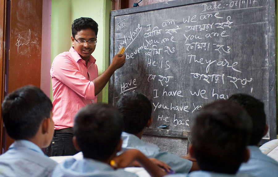 A teacher teaches childer at the Child Sponsorship Program center