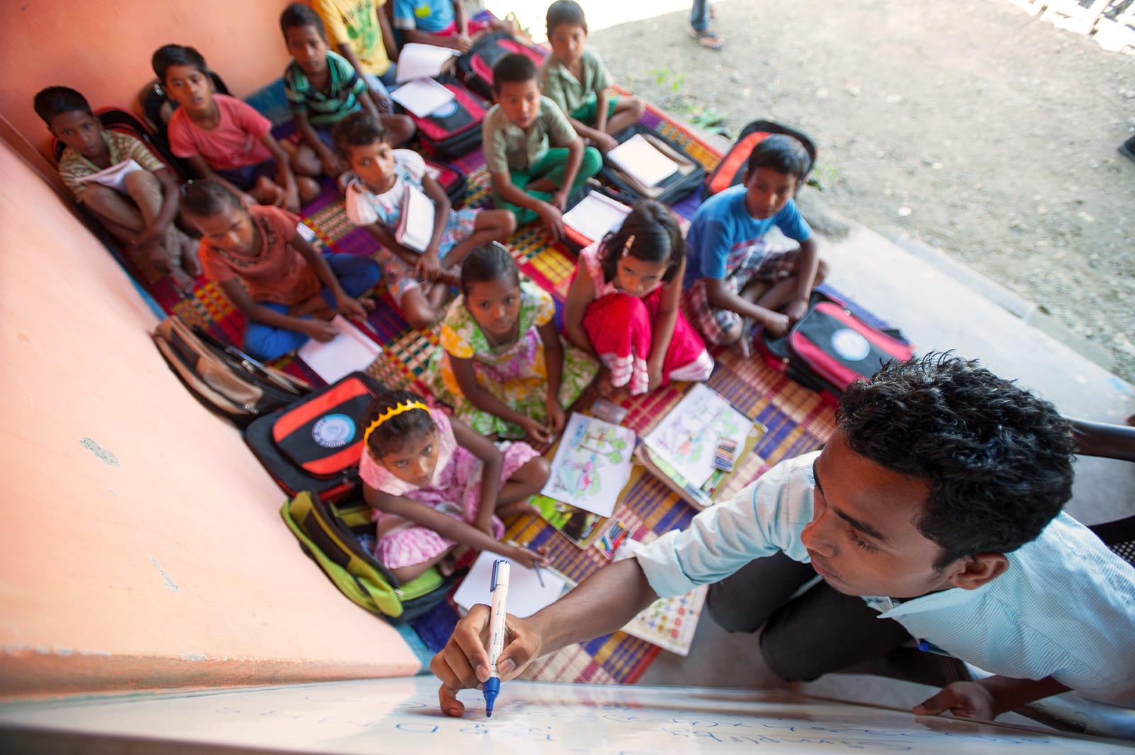 Children listening intently in a Child Sponsorship Program center class